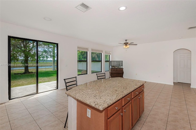 kitchen with visible vents, light tile patterned floors, and a wealth of natural light