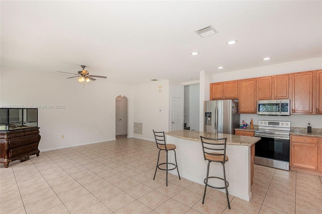 kitchen featuring visible vents, ceiling fan, recessed lighting, arched walkways, and appliances with stainless steel finishes
