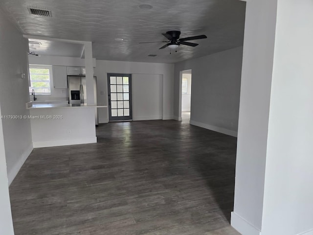 3801 NW 8th Ct, Lauderhill, FL 33311 - unfurnished living room featuring baseboards, dark wood-style flooring, ceiling fan, and visible vents