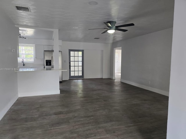 3801 NW 8th Ct, Lauderhill, FL 33311 - unfurnished living room featuring dark wood-style flooring, baseboards, visible vents, and ceiling fan