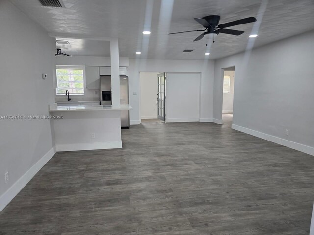 3801 NW 8th Ct, Lauderhill, FL 33311 - unfurnished living room with a ceiling fan, baseboards, dark wood-style floors, recessed lighting, and a sink