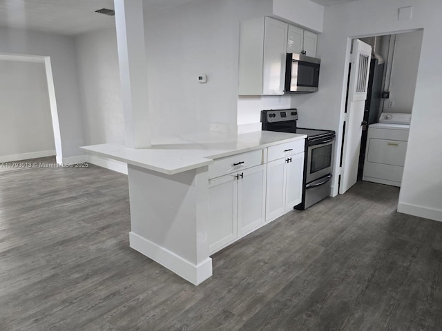 3801 NW 8th Ct, Lauderhill, FL 33311 - kitchen featuring dark wood-style flooring, washer / clothes dryer, white cabinetry, and stainless steel appliances