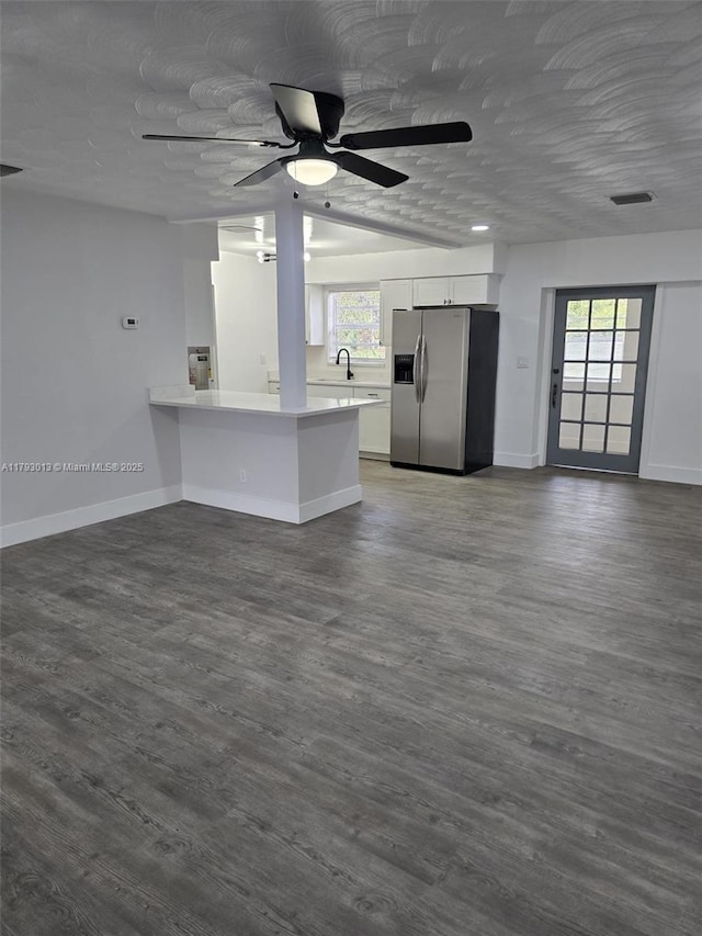 3801 NW 8th Ct, Lauderhill, FL 33311 - unfurnished living room featuring a healthy amount of sunlight, ceiling fan, a sink, baseboards, and dark wood-style floors