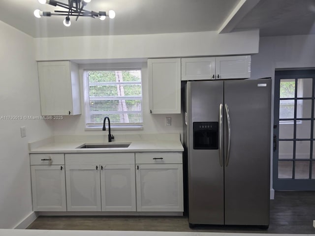 3801 NW 8th Ct, Lauderhill, FL 33311 - kitchen featuring a sink, stainless steel fridge with ice dispenser, light countertops, white cabinetry, and a wealth of natural light
