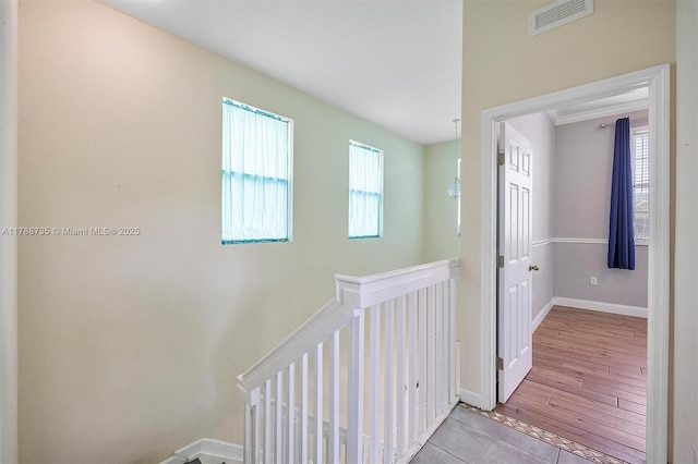 2131 NE 40th Rd, Homestead, FL 33033 - corridor with an upstairs landing, baseboards, and light wood-style flooring