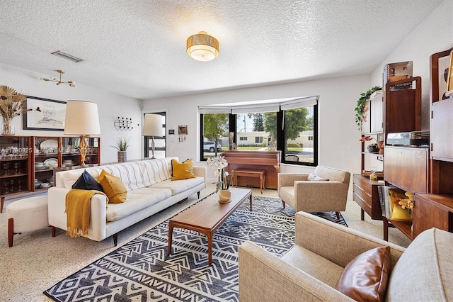 living room featuring a textured ceiling and visible vents
