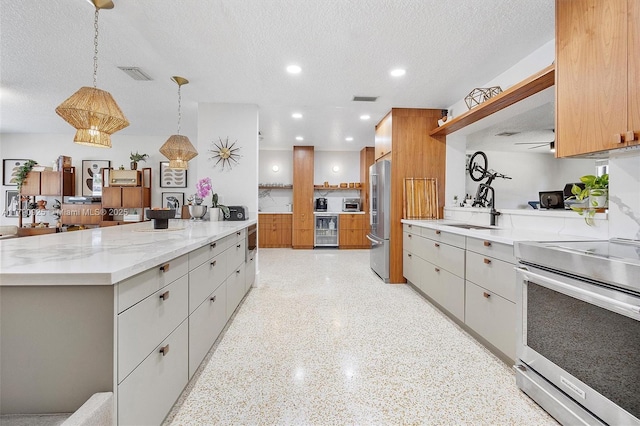 kitchen featuring open shelves, appliances with stainless steel finishes, a sink, beverage cooler, and light speckled floor