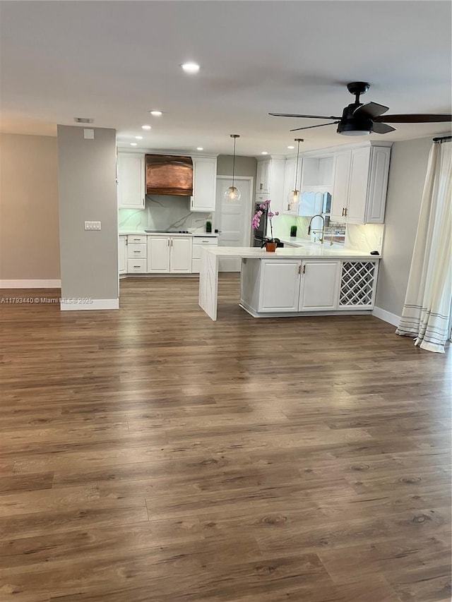 14520 SW 79th Ct, Palmetto Bay, FL 33158 - kitchen featuring white cabinetry, a peninsula, custom range hood, dark wood-style floors, and recessed lighting