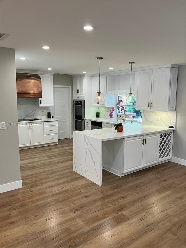 14520 SW 79th Ct, Palmetto Bay, FL 33158 - kitchen with custom exhaust hood, backsplash, white cabinets, a peninsula, and recessed lighting