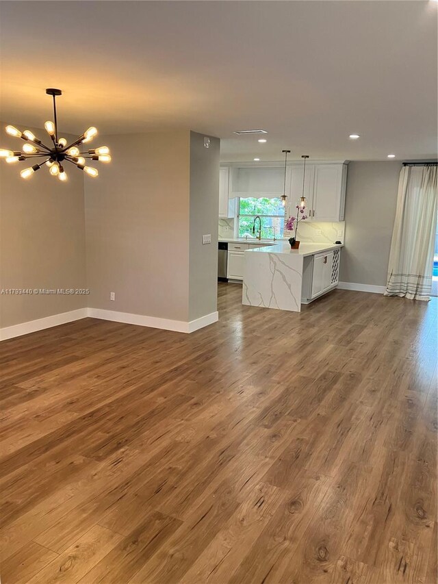 14520 SW 79th Ct, Palmetto Bay, FL 33158 - unfurnished living room with a chandelier, wood finished floors, and recessed lighting