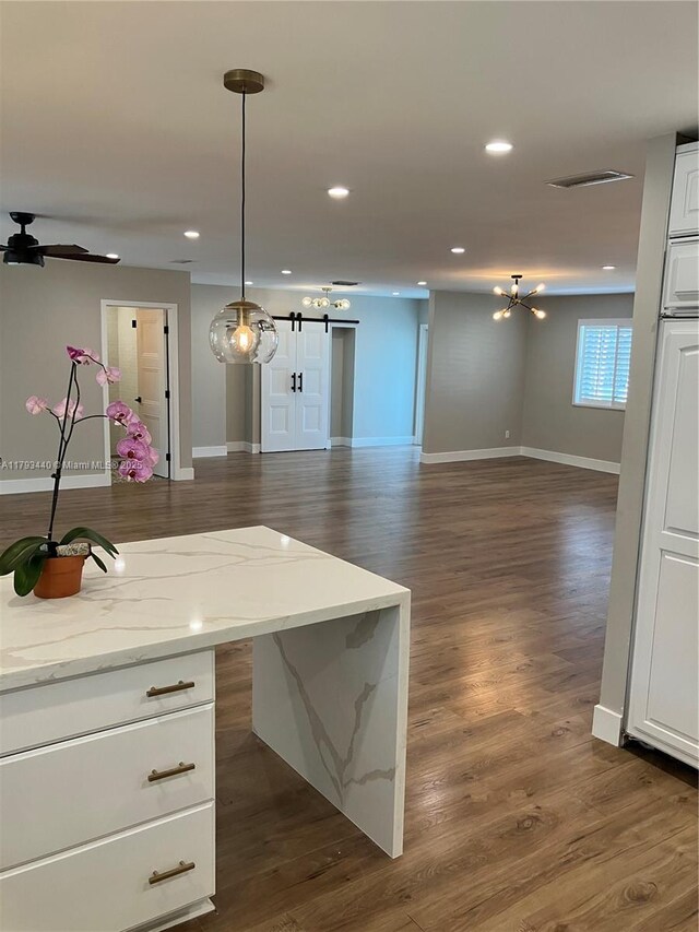14520 SW 79th Ct, Palmetto Bay, FL 33158 - kitchen featuring open floor plan, white cabinetry, dark wood-style flooring, a barn door, and recessed lighting