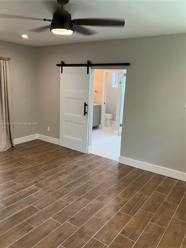 14520 SW 79th Ct, Palmetto Bay, FL 33158 - unfurnished room featuring a barn door, a ceiling fan, and dark wood finished floors