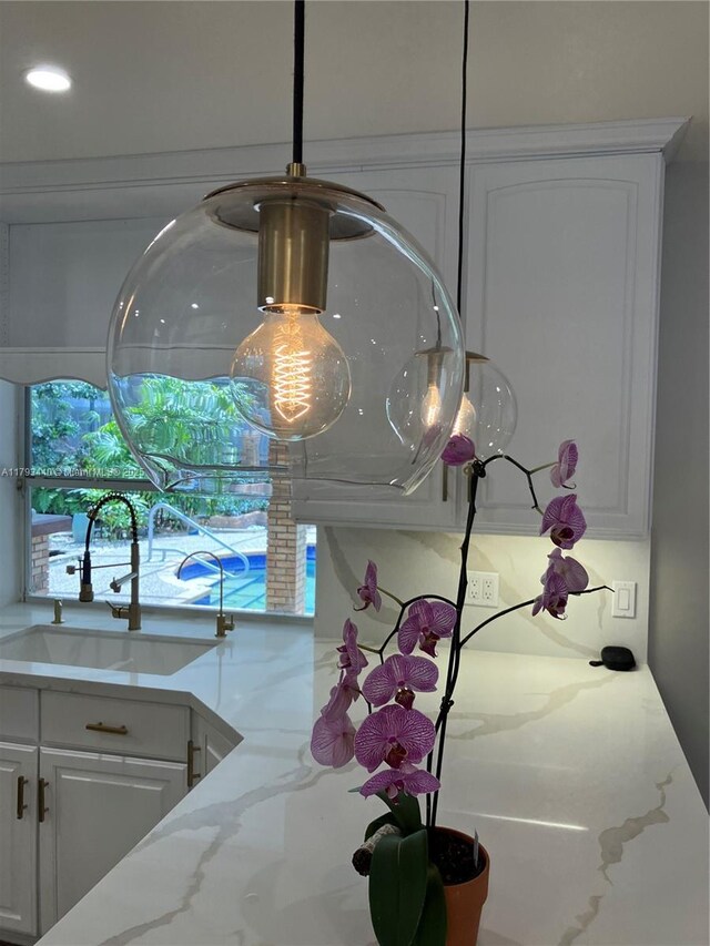 14520 SW 79th Ct, Palmetto Bay, FL 33158 - kitchen view of white cabinets, light stone countertops, and recessed lighting