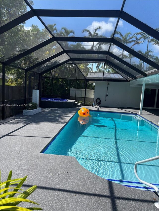 14520 SW 79th Ct, Palmetto Bay, FL 33158 - view of swimming pool featuring a patio area, a pool with connected hot tub, and glass enclosure