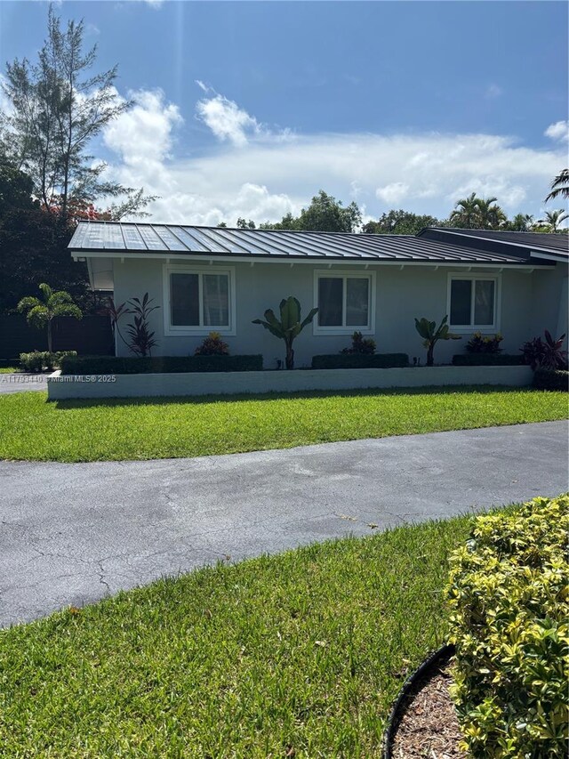 14520 SW 79th Ct, Palmetto Bay, FL 33158 - ranch-style home with stucco siding, a front lawn, a standing seam roof, and a metal roof