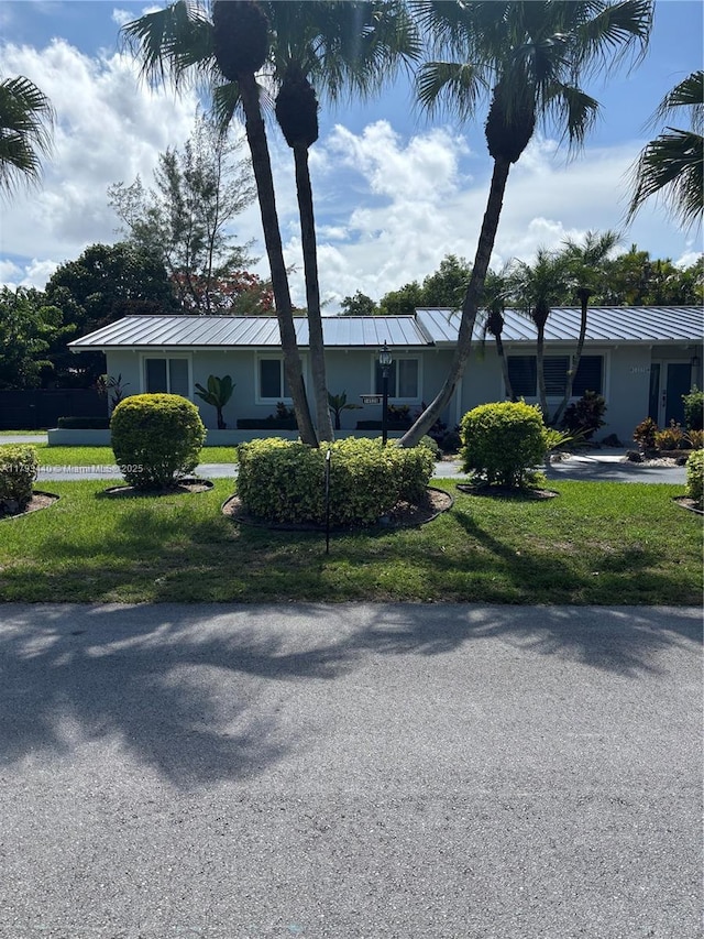 14520 SW 79th Ct, Palmetto Bay, FL 33158 - ranch-style home with a front lawn, a standing seam roof, and stucco siding