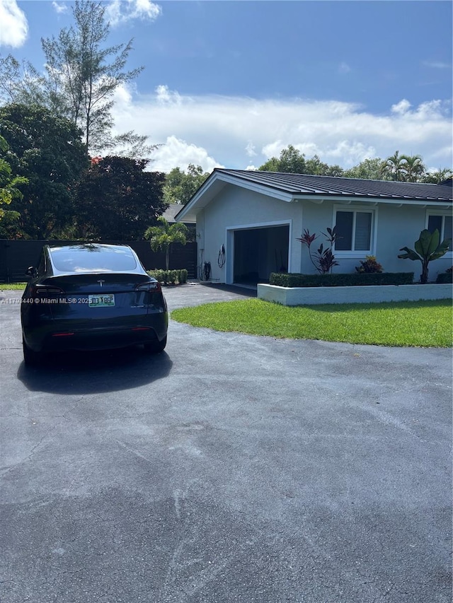 14520 SW 79th Ct, Palmetto Bay, FL 33158 - view of side of home with driveway, a garage, and stucco siding