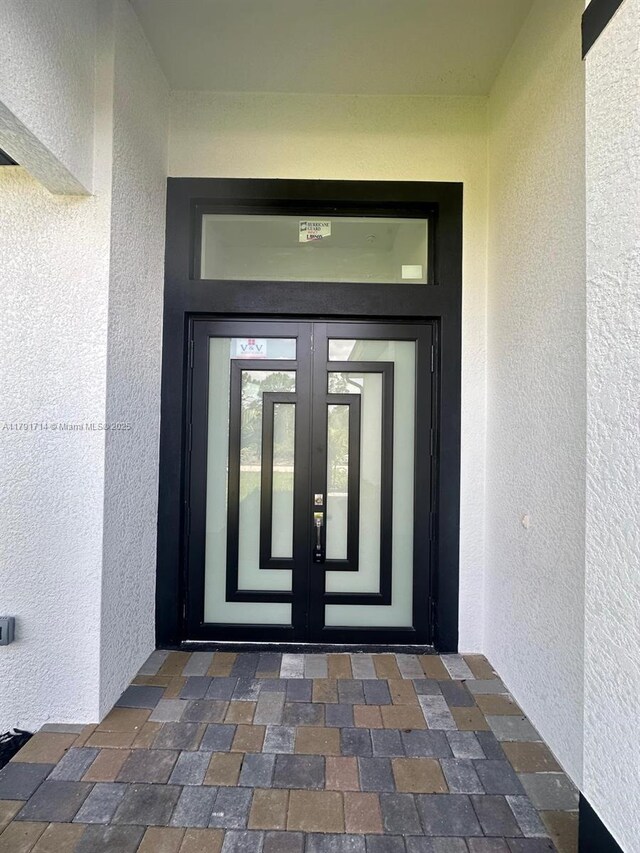 1022 Candleligth St, Lehigh Acres, FL 33974 - entrance to property with french doors and stucco siding
