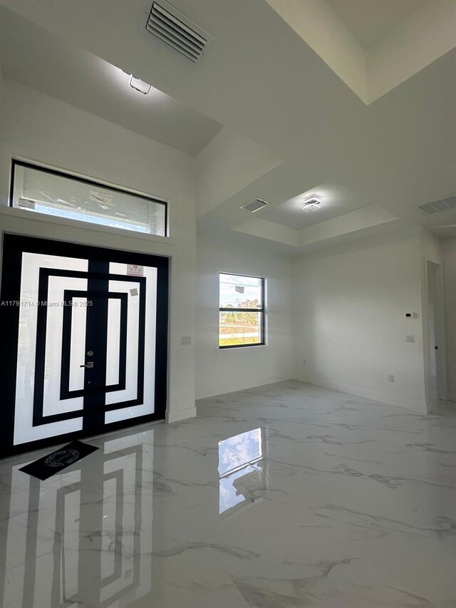 1022 Candleligth St, Lehigh Acres, FL 33974 - foyer entrance with marble finish floor, baseboards, visible vents, and a raised ceiling