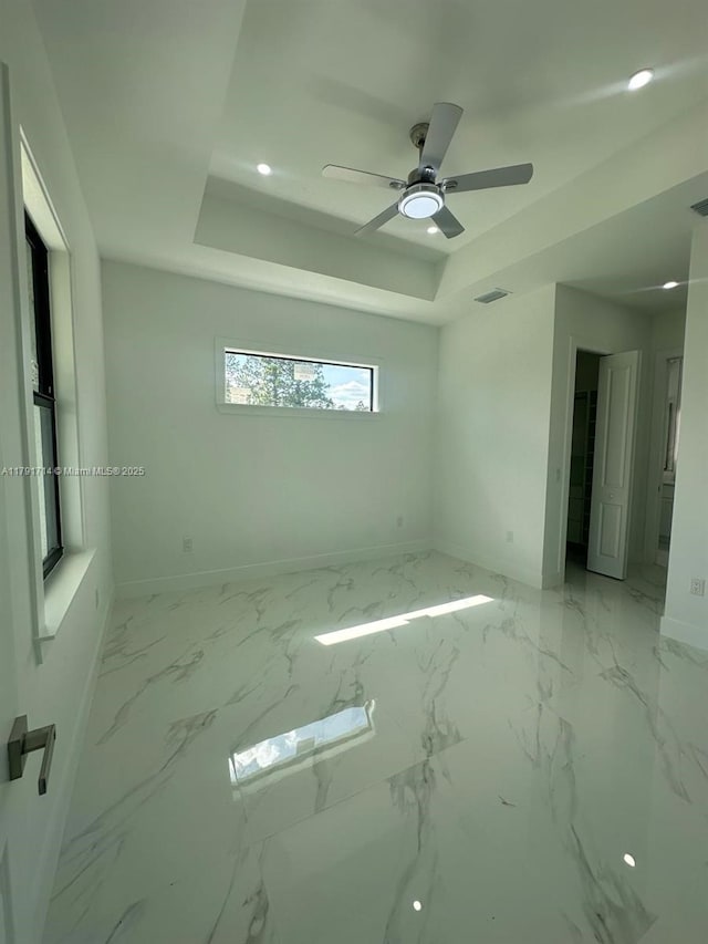 1022 Candleligth St, Lehigh Acres, FL 33974 - empty room with baseboards, ceiling fan, a tray ceiling, and visible vents
