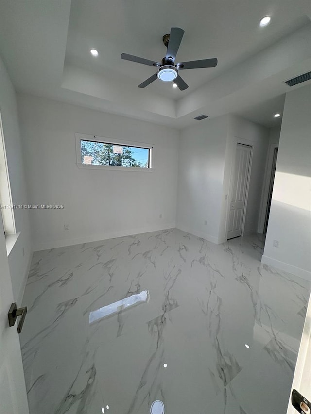 1022 Candleligth St, Lehigh Acres, FL 33974 - spare room featuring a ceiling fan, visible vents, a raised ceiling, baseboards, and recessed lighting