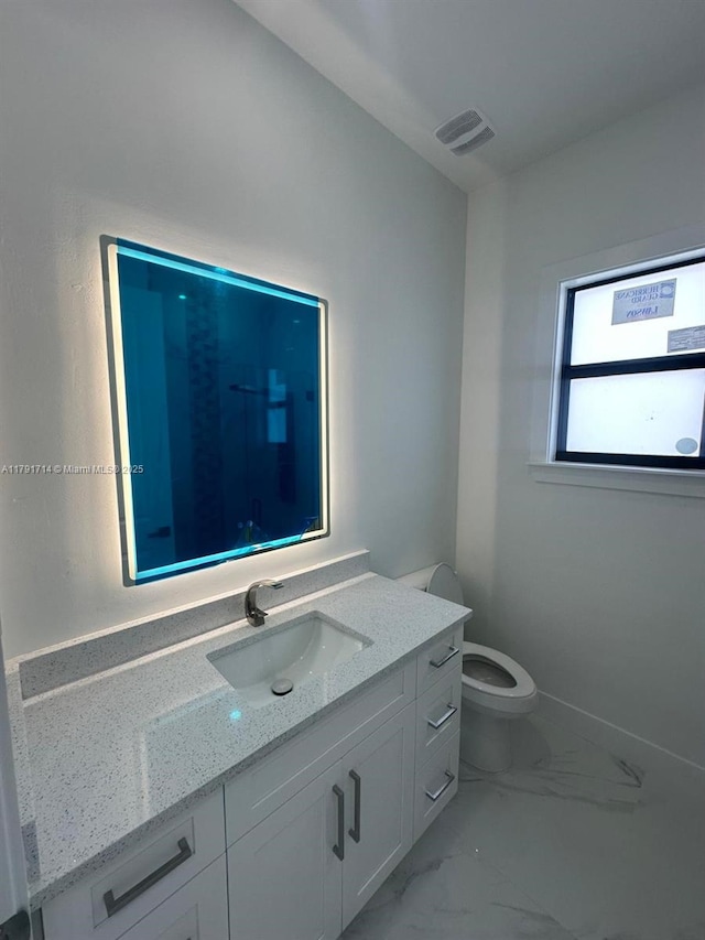 1022 Candleligth St, Lehigh Acres, FL 33974 - bathroom featuring toilet, visible vents, marble finish floor, and vanity