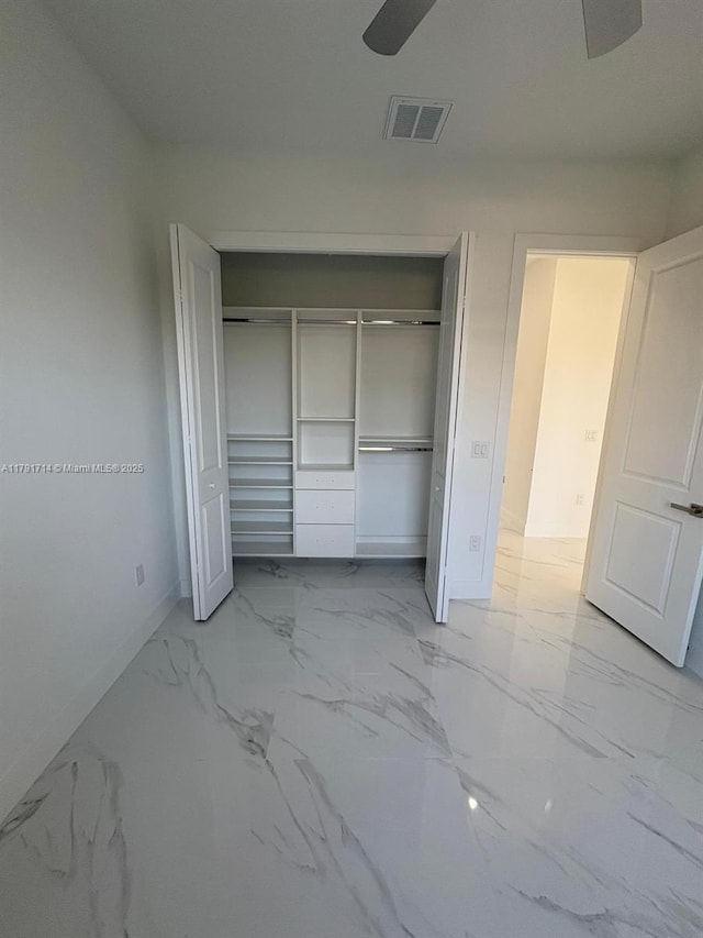 1022 Candleligth St, Lehigh Acres, FL 33974 - unfurnished bedroom featuring visible vents, marble finish floor, baseboards, and a closet
