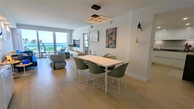 dining space featuring light wood-style floors