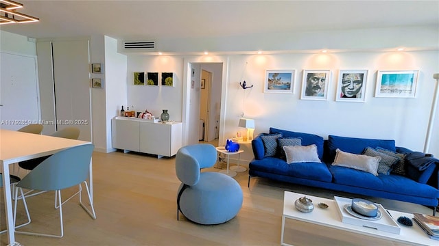 living room featuring visible vents and light wood-style flooring