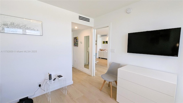 hallway featuring visible vents and light wood-style flooring