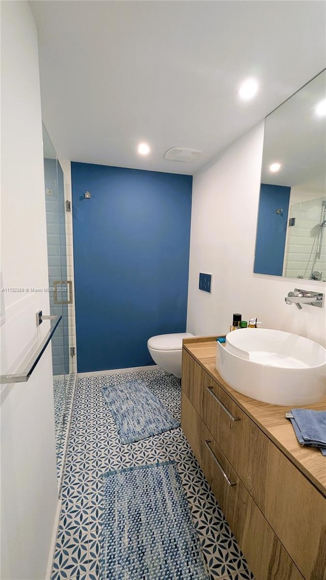 bathroom featuring tile patterned flooring, vanity, toilet, recessed lighting, and a shower stall