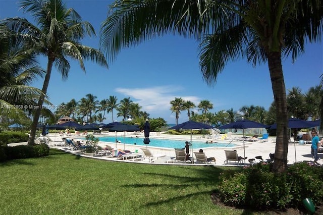 community pool featuring a yard and a patio