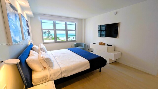 bedroom featuring light wood-style floors and baseboards