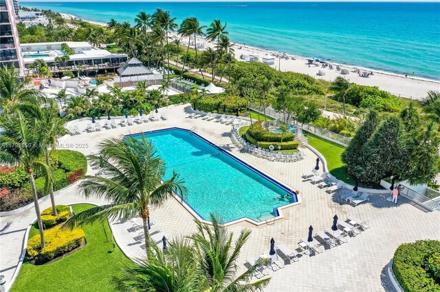 community pool with a view of the beach and a water view