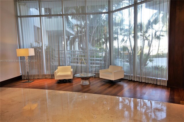 5151 Collins Ave Unit 634, Miami Beach, FL 33140 - sitting room featuring a healthy amount of sunlight and wood finished floors