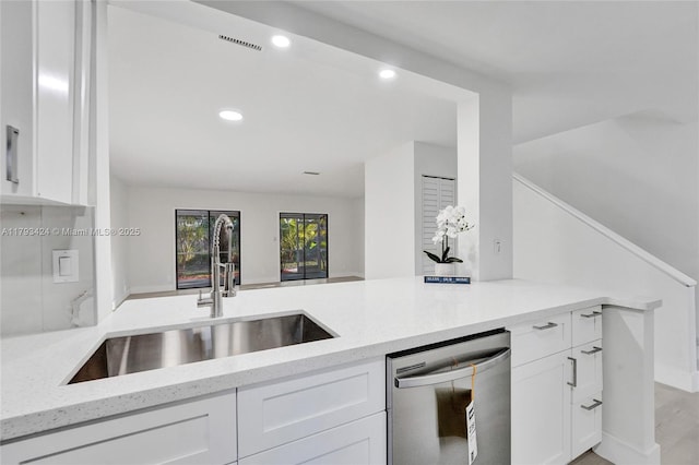 856 NW 47th St Unit 856, Deerfield Beach, FL 33064 - kitchen featuring stainless steel dishwasher, a sink, white cabinetry, and light stone countertops