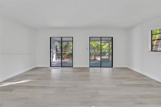 856 NW 47th St Unit 856, Deerfield Beach, FL 33064 - spare room with baseboards and light wood finished floors