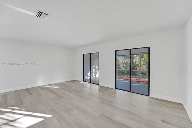 856 NW 47th St Unit 856, Deerfield Beach, FL 33064 - spare room with light wood-style flooring and baseboards