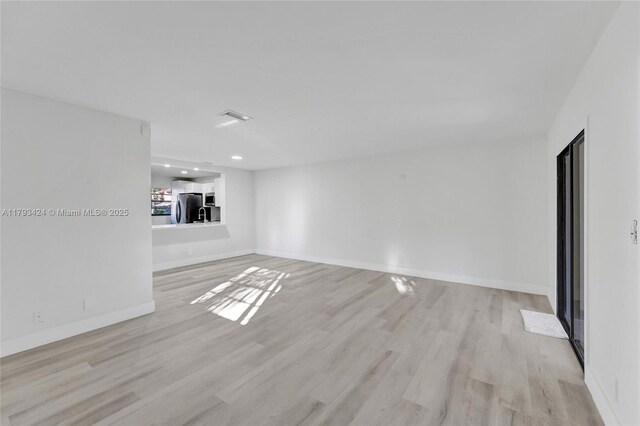 856 NW 47th St Unit 856, Deerfield Beach, FL 33064 - unfurnished living room featuring light wood-style flooring and recessed lighting
