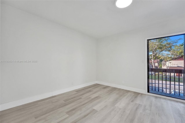 856 NW 47th St Unit 856, Deerfield Beach, FL 33064 - unfurnished room with baseboards and wood finished floors