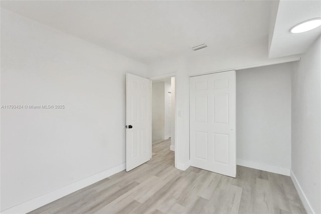 856 NW 47th St Unit 856, Deerfield Beach, FL 33064 - unfurnished bedroom with baseboards, a closet, light wood-type flooring, and visible vents