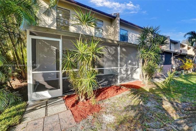 856 NW 47th St Unit 856, Deerfield Beach, FL 33064 - back of property featuring a sunroom and stucco siding