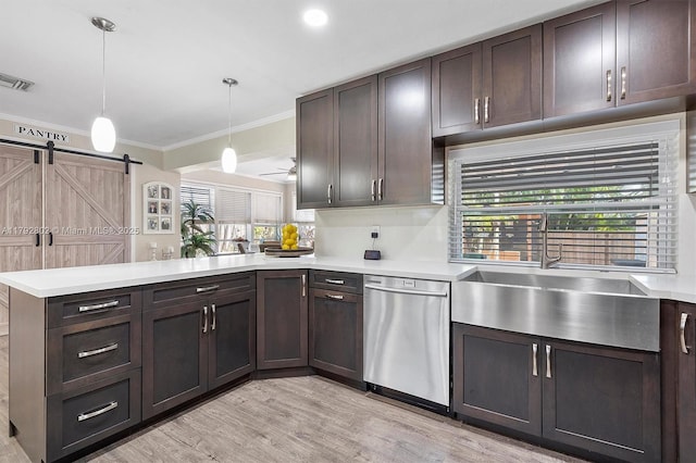 kitchen featuring a healthy amount of sunlight, visible vents, light countertops, a peninsula, and ornamental molding