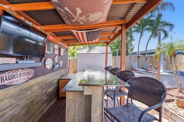 view of patio featuring a fenced backyard, an outbuilding, and a storage shed