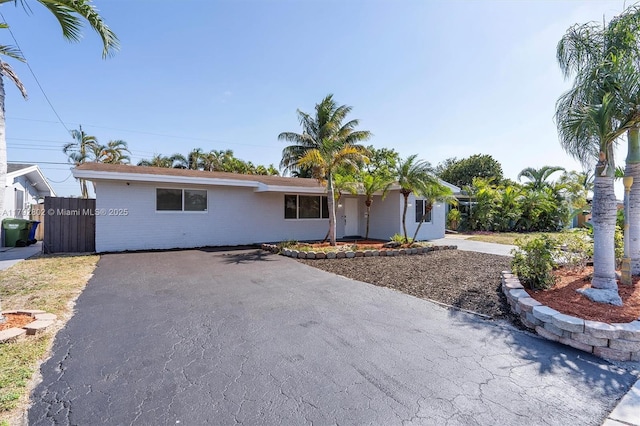 single story home featuring aphalt driveway