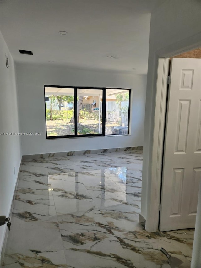 unfurnished room featuring plenty of natural light