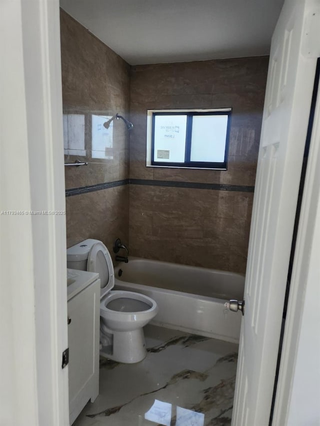 full bathroom featuring shower / bathing tub combination, washing machine and dryer, vanity, toilet, and marble finish floor