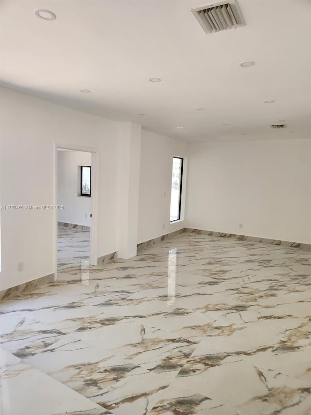 spare room with baseboards, marble finish floor, recessed lighting, and visible vents