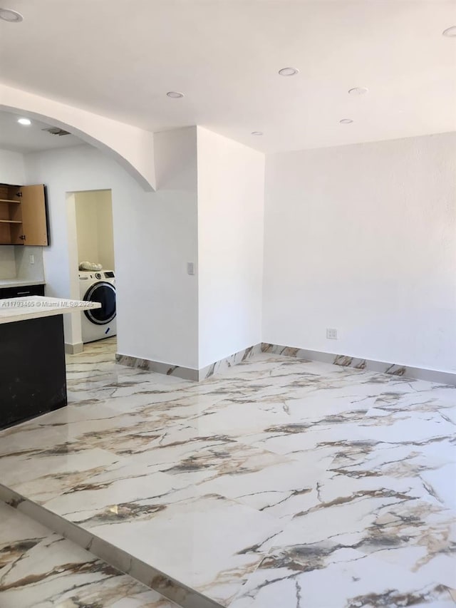 unfurnished room with washer / clothes dryer, recessed lighting, baseboards, and marble finish floor