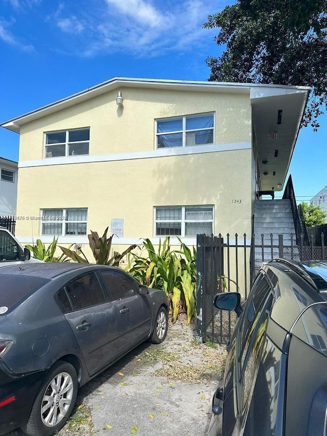 view of home's exterior featuring fence and stucco siding